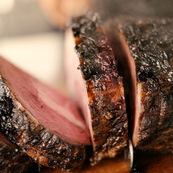Logan's Roadhouse signature dishes Mesquite-Grilled Ribeye, "The Logan" Sirloin Steak, and yeast rolls.